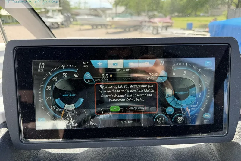 Slide: The Image of 2019 Malibu Wakesetter 24 MXZ dashboard display with speedometer and safety message. - 24