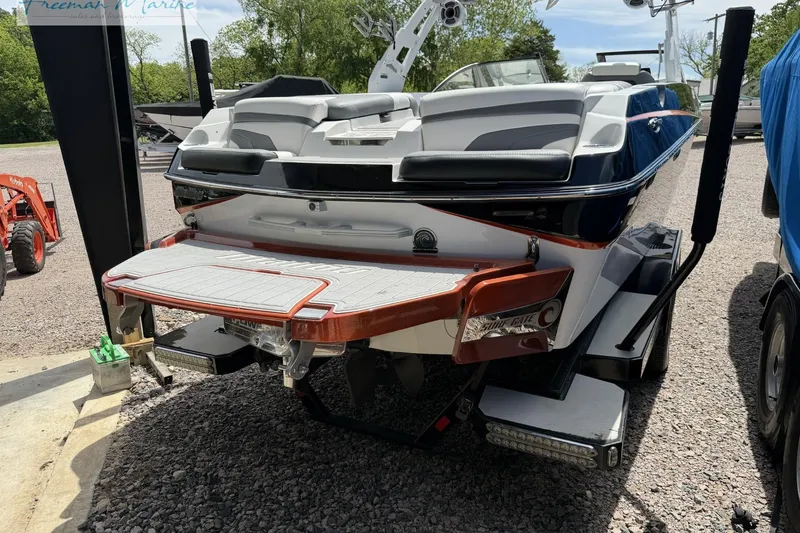 Slide: The Image of 2019 Malibu Wakesetter 24 MXZ boat on trailer, rear view, in outdoor setting. - 3