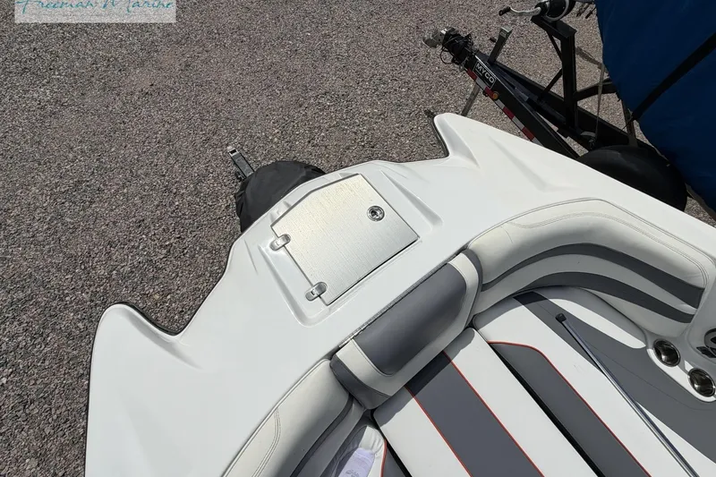 Slide: The Image of 2019 Malibu Wakesetter 24 MXZ boat interior with sleek seating and storage compartment. - 9