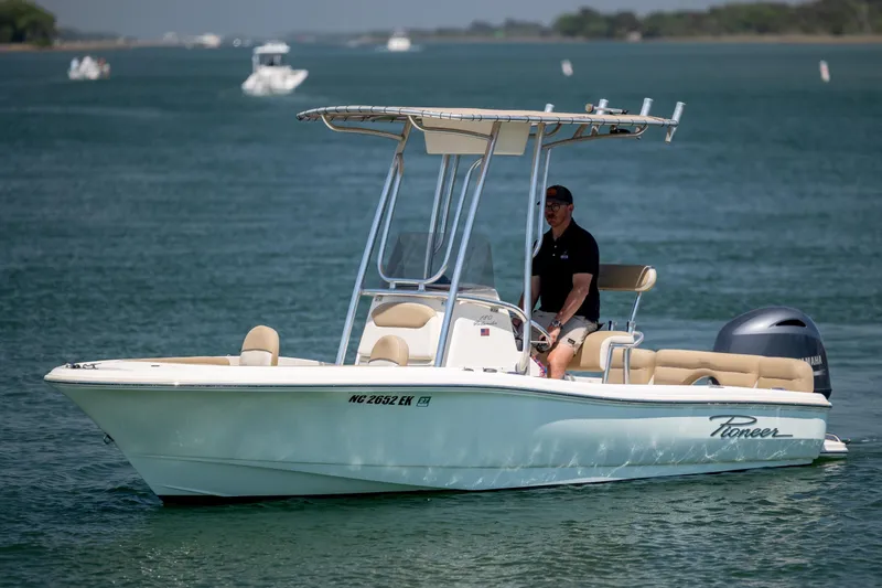 The Image of 2019 Pioneer 180 Islander boat on water with a person at the helm. - 1