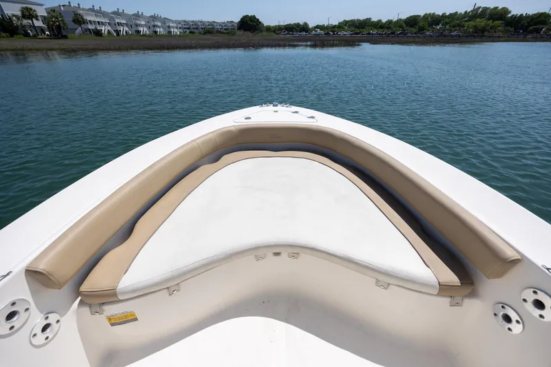 Slide: The Image of Bow seating area of 2019 Pioneer 180 Islander boat on calm water. - 11
