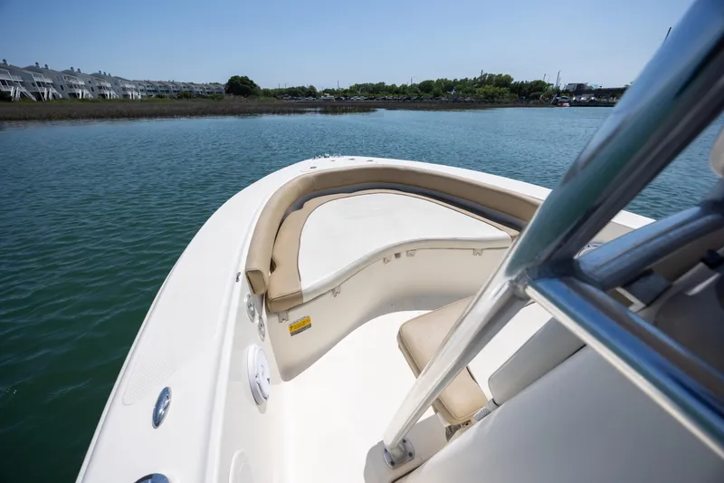 Slide: The Image of 2019 Pioneer 180 Islander boat on calm water, featuring spacious seating and sleek design. - 12