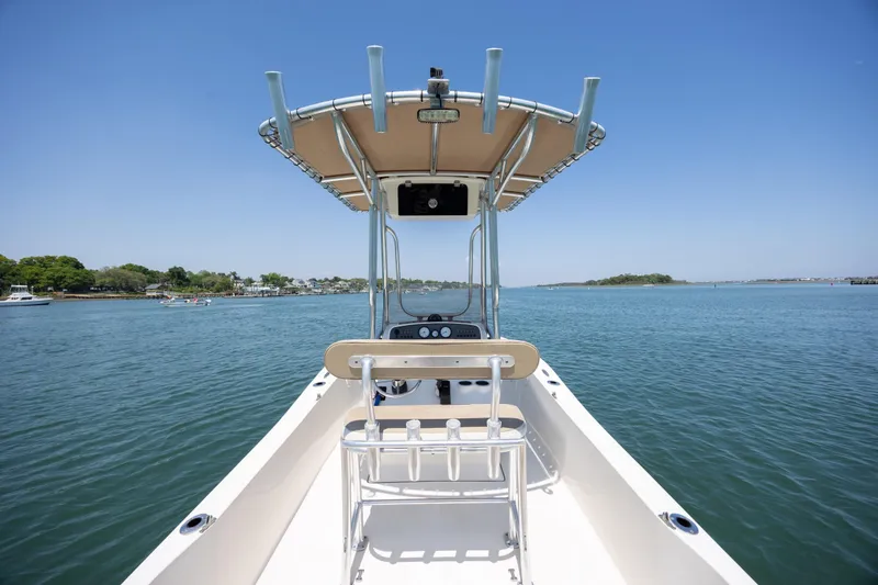 Slide: The Image of 2019 Pioneer 180 Islander boat on calm water under clear blue sky. - 16