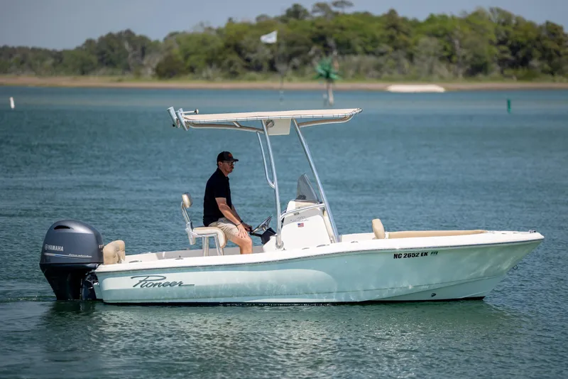 Slide: The Image of 2019 Pioneer 180 Islander boat cruising on a calm lake with a Yamaha engine. - 5