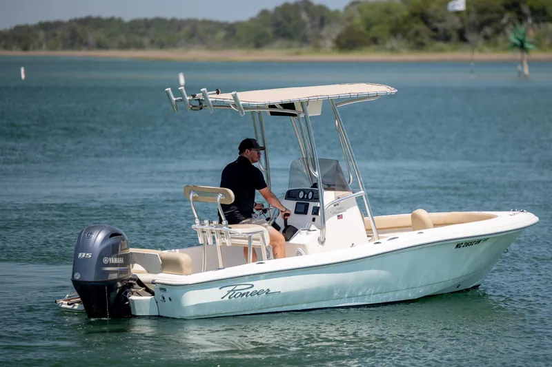Slide: The Image of 2019 Pioneer 180 Islander boat with Yamaha engine cruising on a calm lake. - 6