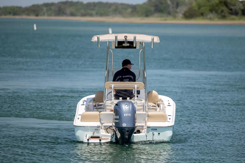 Slide: The Image of 2019 Pioneer 180 Islander boat cruising on a serene lake with a Yamaha engine. - 7