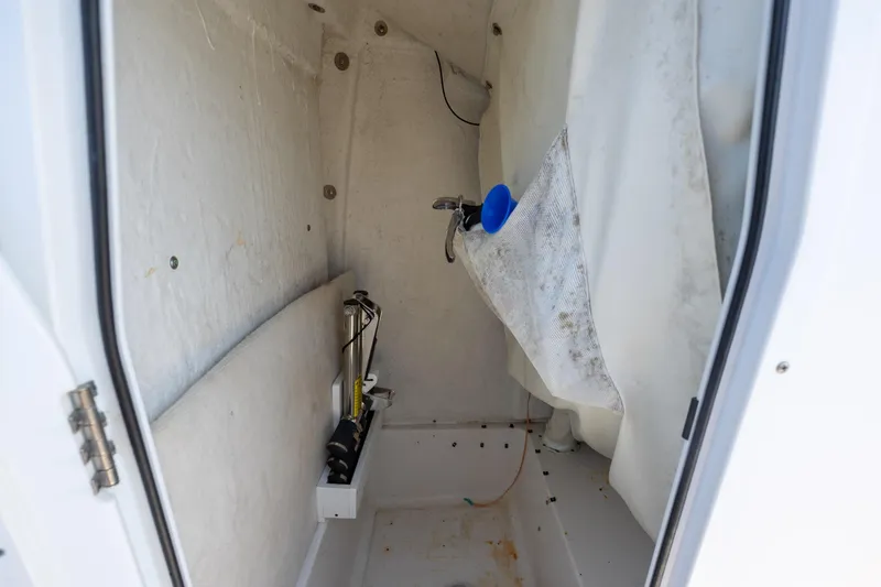 Slide: The Image of Interior storage compartment of 2018 Sea Hunt Ultra 235 SE boat, featuring utility items. - 14