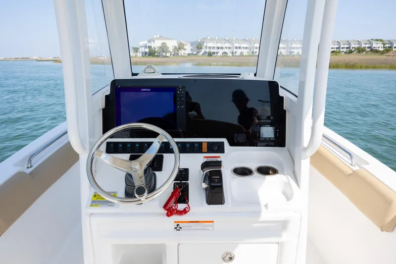 Slide: The Image of Cockpit of 2018 Sea Hunt Ultra 235 SE boat with steering wheel and navigation system. - 17