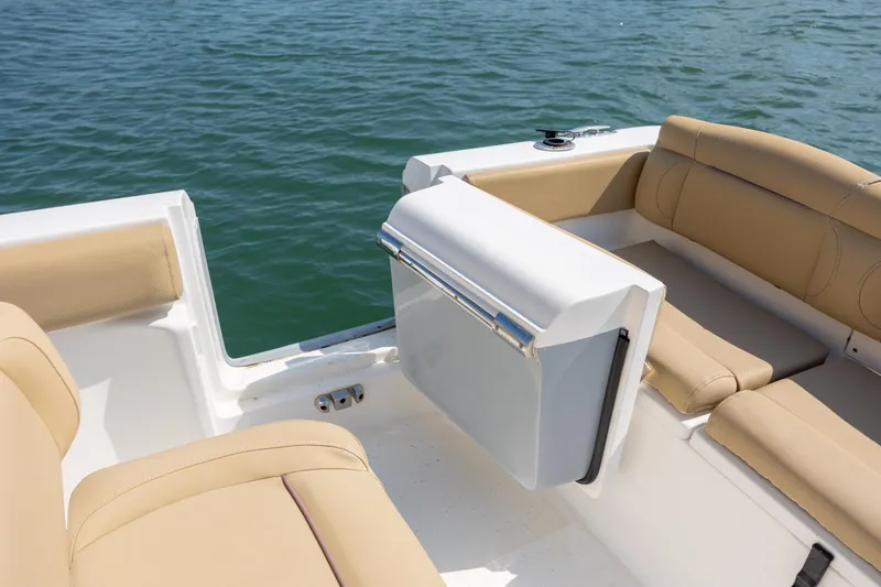 Slide: The Image of 2018 Sea Hunt Ultra 235 SE boat interior with tan seating, on calm water. - 22