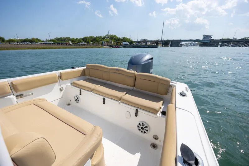 Slide: The Image of 2018 Sea Hunt Ultra 235 SE boat with tan seating, cruising on a sunny day. - 26