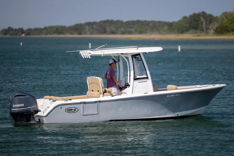 Slide: The Image of 2018 Sea Hunt Ultra 235 SE boat cruising on a calm lake with Yamaha engine. - 3