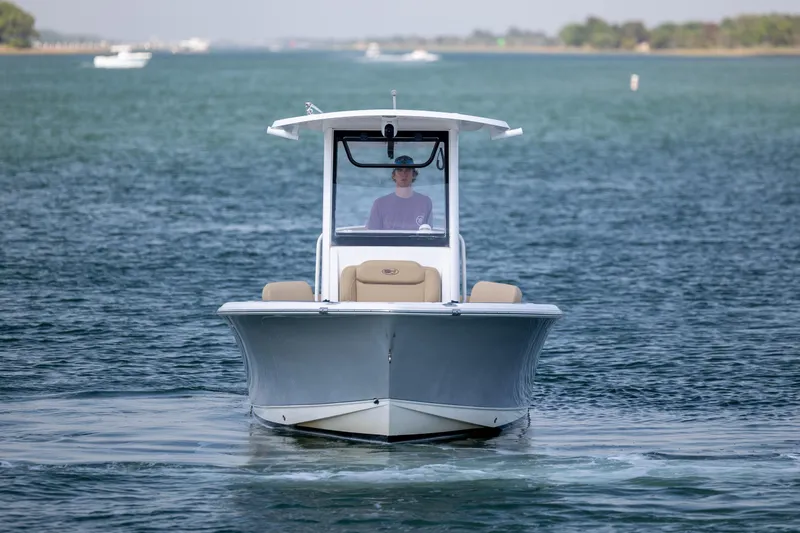 Slide: The Image of 2018 Sea Hunt Ultra 235 SE boat cruising on a calm waterway. - 4