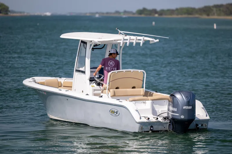 Slide: The Image of 2018 Sea Hunt Ultra 235 SE boat cruising on a calm waterway. - 7