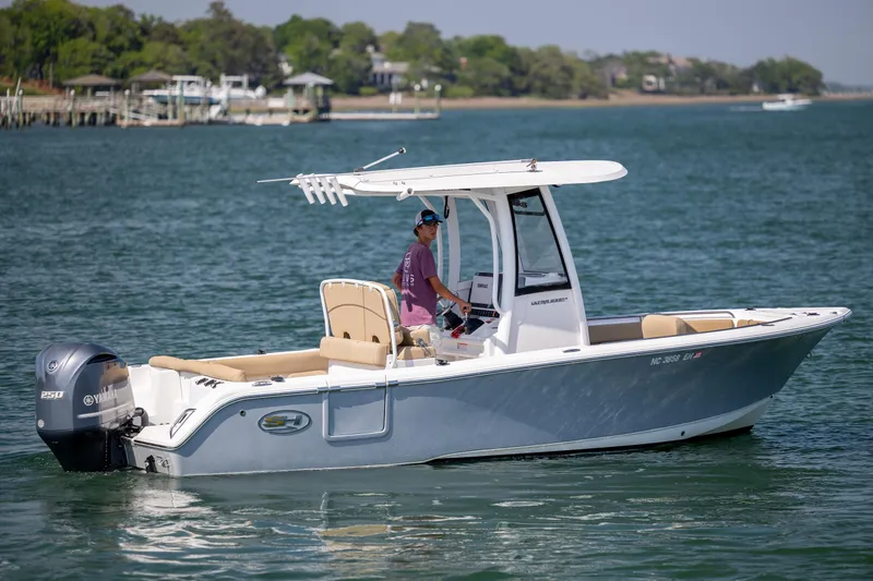 Slide: The Image of 2018 Sea Hunt Ultra 235 SE boat cruising on a calm lake. - 8