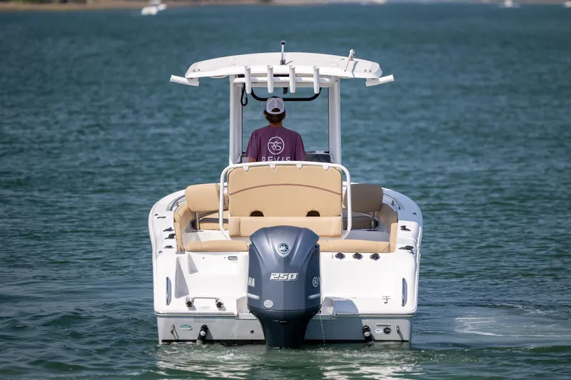 Slide: The Image of 2018 Sea Hunt Ultra 235 SE boat on water, rear view with Yamaha engine. - 9