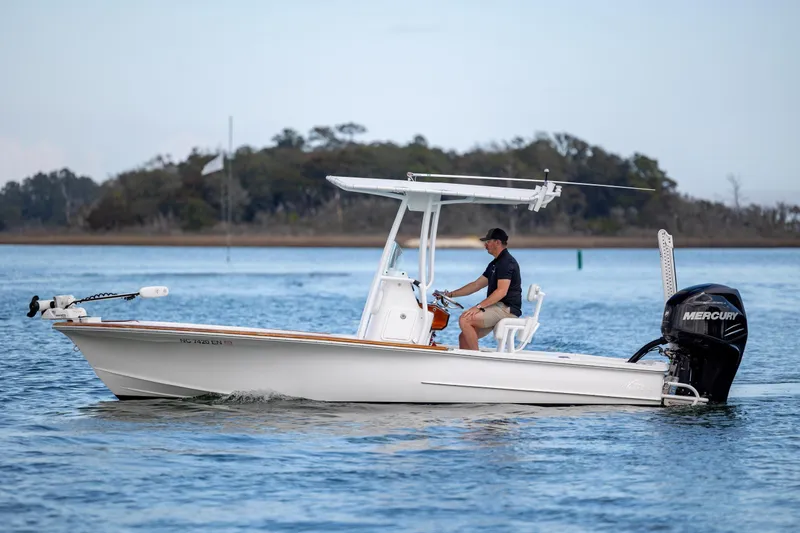 The Image of 2017 Chaos 21 Tarpon Bay boat cruising on calm water with a Mercury engine. - 1