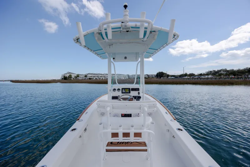 Slide: The Image of 2017 Chaos 21 Tarpon Bay boat on calm water, featuring a sleek design and modern controls. - 24