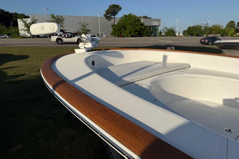 Slide: The Image of 2017 Chaos 21 Tarpon Bay boat with wooden trim, parked outdoors near a dealership. - 27