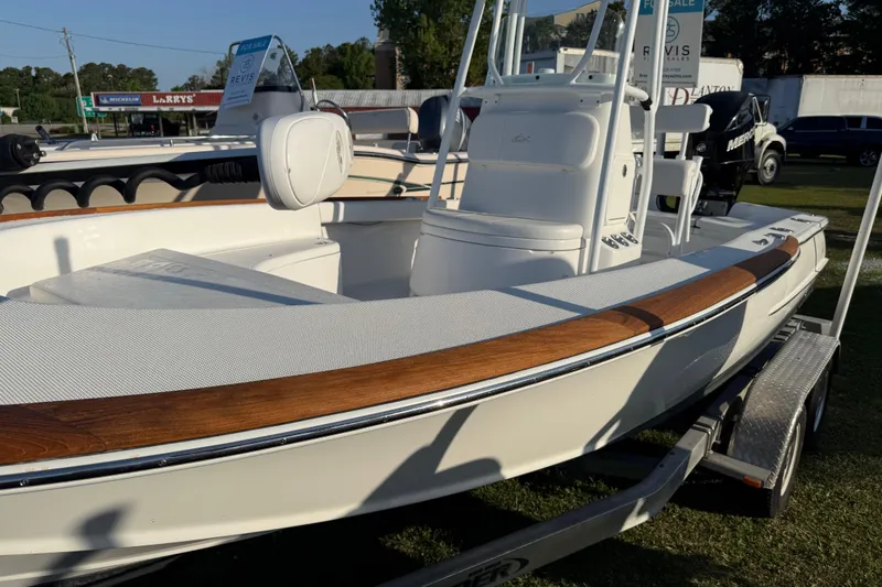 Slide: The Image of 2017 Chaos 21 Tarpon Bay boat on trailer, featuring sleek design and wood accents. - 28