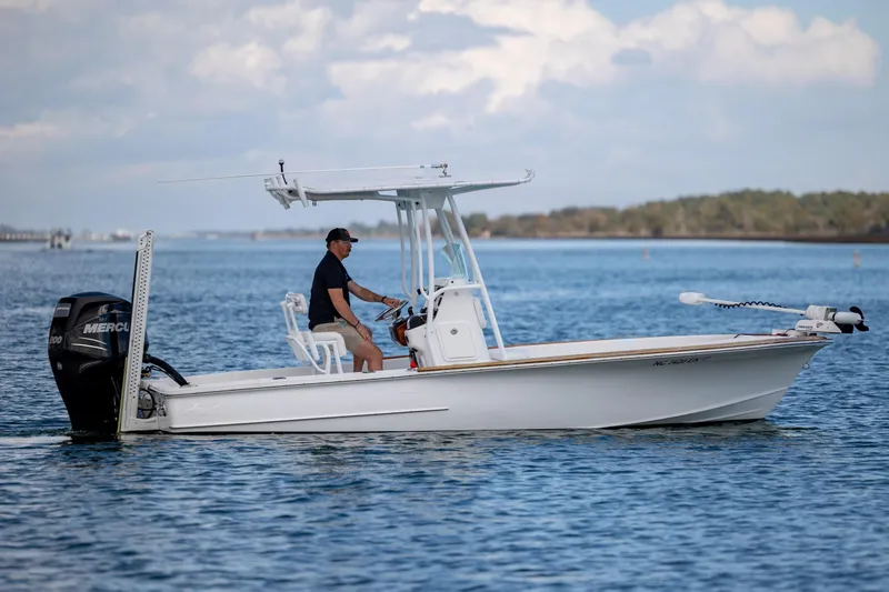 Slide: The Image of 2017 Chaos 21 Tarpon Bay boat cruising on calm water with a person steering. - 5