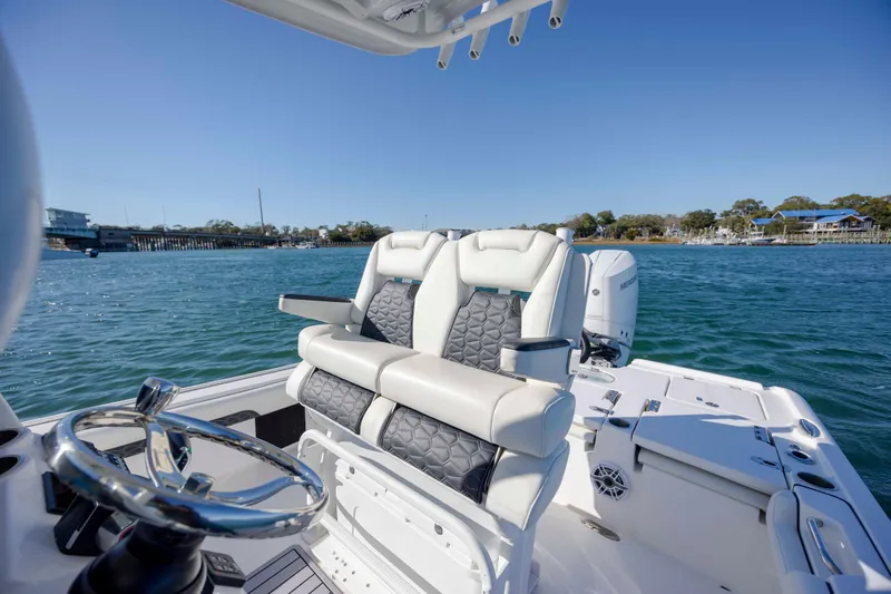 Slide: The Image of 2024 Tidewater 2500 Carolina Bay boat interior with luxurious seating on a sunny day. - 15