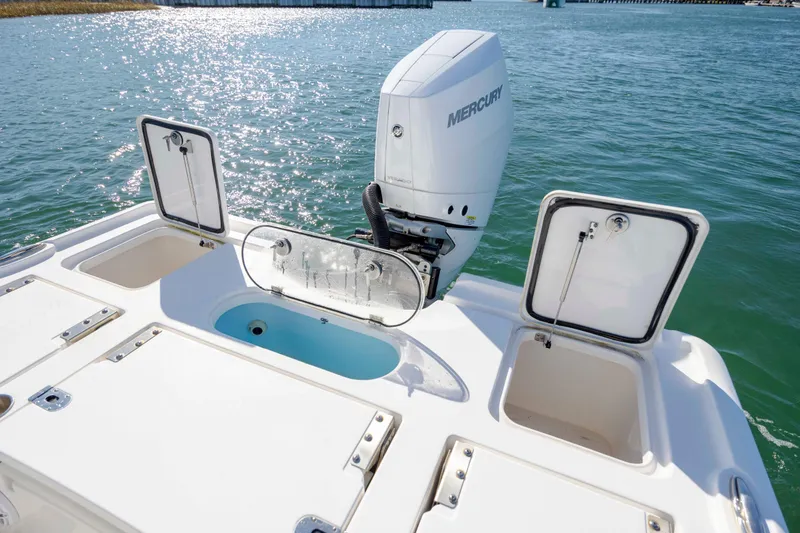 Slide: The Image of 2024 Tidewater 2500 Carolina Bay boat with Mercury engine on water. - 16