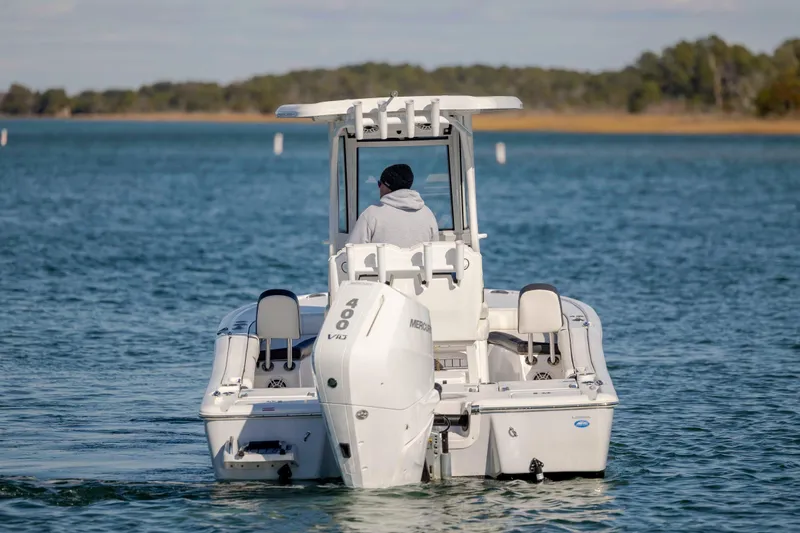 Slide: The Image of 2024 Tidewater 2500 Carolina Bay boat cruising on a serene lake. - 7