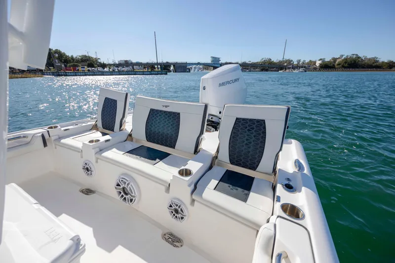Slide: The Image of 2024 Tidewater 2500 Carolina Bay boat with Mercury engine on scenic waterway. - 8