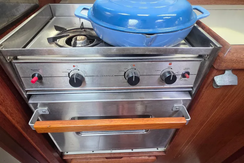 Slide: The Image of Stainless steel stove with blue pot on a 1995 Hunter 336 sailboat. - 11