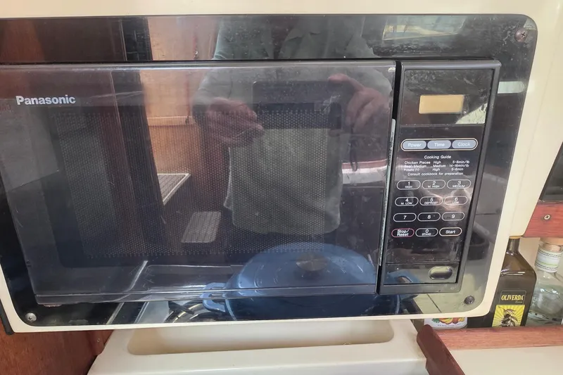 Slide: The Image of Panasonic microwave in a 1995 Hunter 336 yacht kitchen setting. - 13