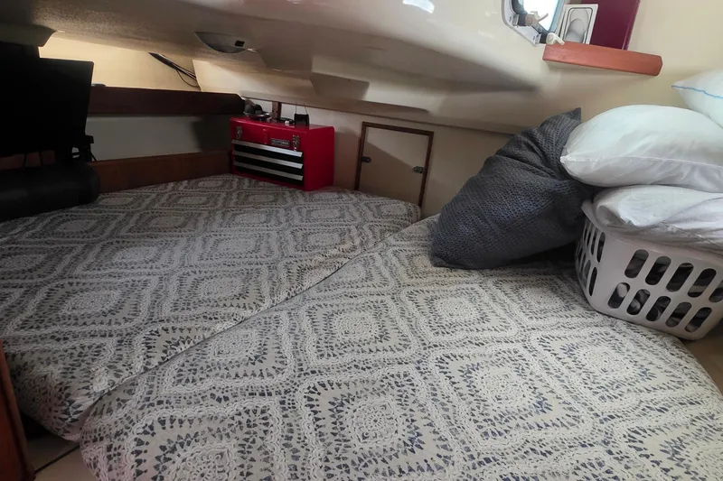 Slide: The Image of Cozy cabin interior of 1995 Hunter 336 sailboat with bedding and storage. - 14