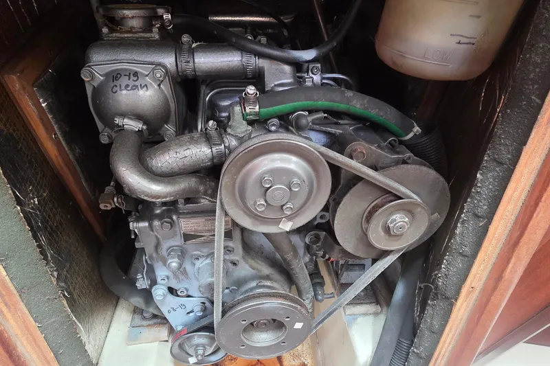 Slide: The Image of Engine compartment of a 1995 Hunter 336 sailboat, showing belts and hoses. - 18