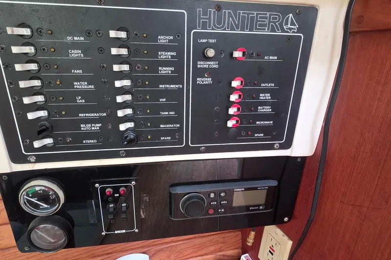 Slide: The Image of Control panel of a 1995 Hunter 336 sailboat with various switches and gauges. - 20