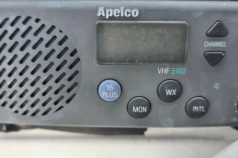 Slide: The Image of Close-up of Apelco VHF 5160 marine radio with control buttons and speaker grille. - 24