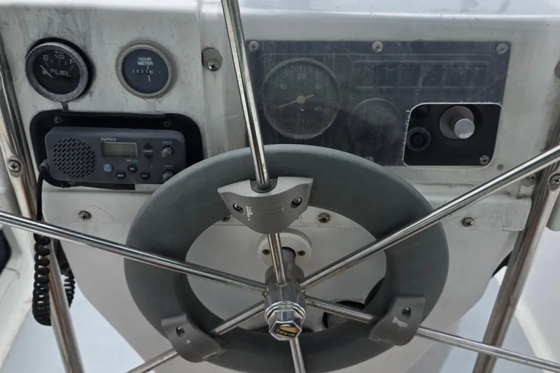 Slide: The Image of Steering wheel and controls of a 1995 Hunter 336 sailboat cockpit. - 26