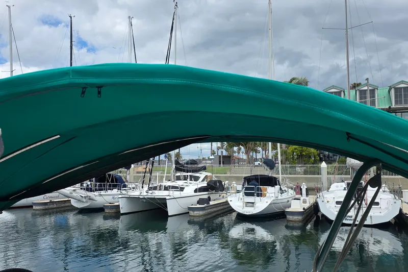 Slide: The Image of Marina view with Hunter 336 sailboat, 1995 model, under teal canopy on a cloudy day. - 29