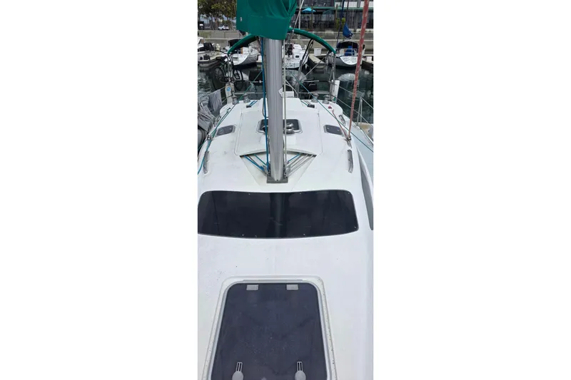 Slide: The Image of Sailboat deck view of a 1995 Hunter 336, docked in a marina. - 31