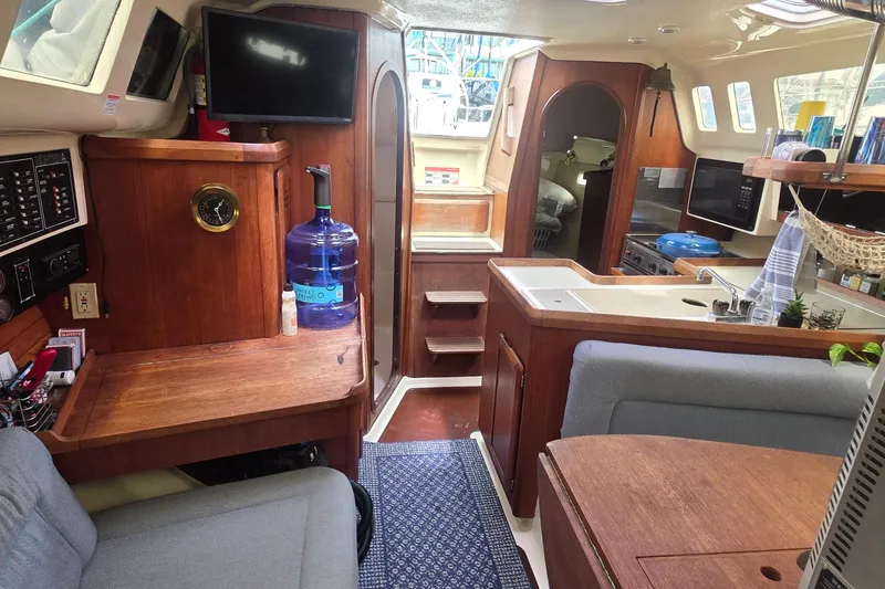 Slide: The Image of Interior of a 1995 Hunter 336 sailboat featuring a cozy kitchen and seating area. - 7