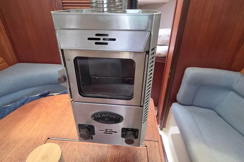 Slide: The Image of Stainless steel stove in 1995 Hunter 336 yacht interior, featuring cozy seating and wooden accents. - 8