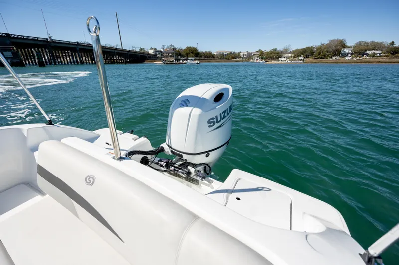Slide: The Image of 2023 Hurricane SunDeck 187 OB boat with Suzuki outboard motor on scenic waterway. - 14