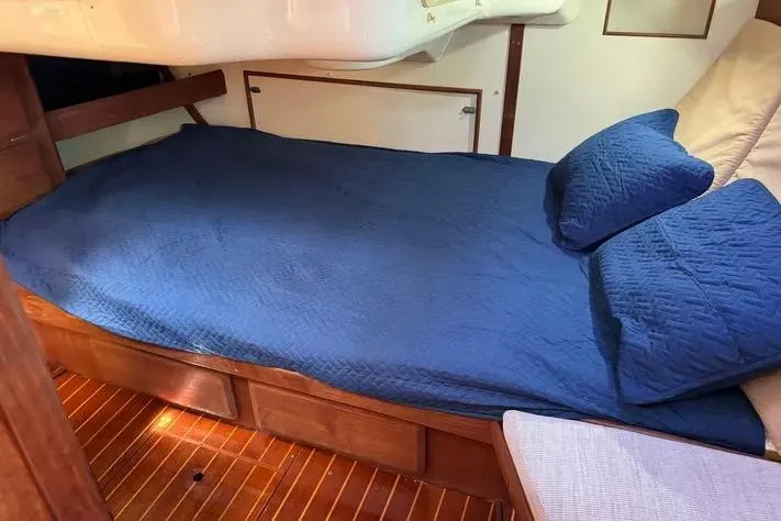 Slide: The Image of Cozy cabin bed with blue bedding in 1993 Hunter Vision 36 sailboat. - 10
