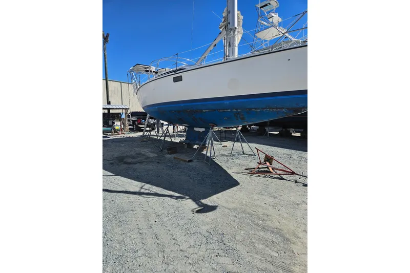 Slide: The Image of Sailboat Hunter Vision 36, 1993 model, on stands in a boatyard under clear blue sky. - 12