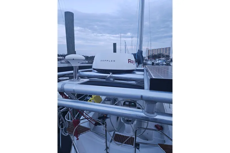 Slide: The Image of Hunter Vision 36 sailboat, 1993 model, featuring radar and solar panels at a marina. - 2
