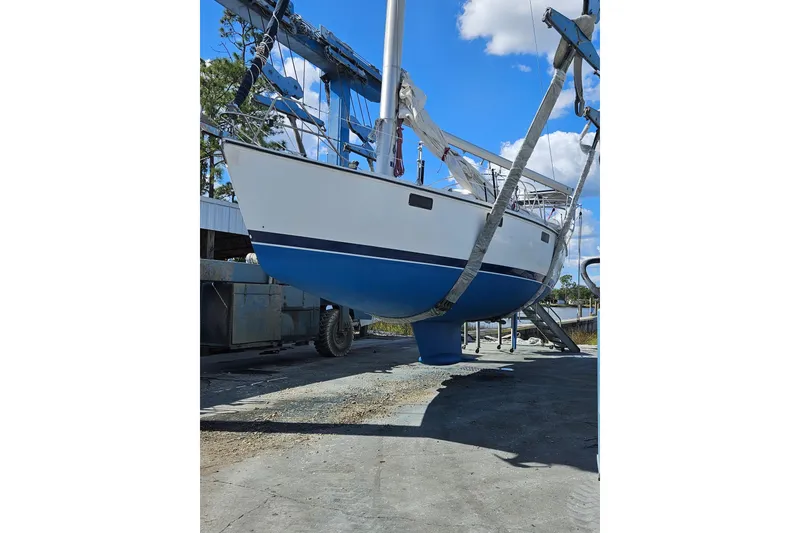Slide: The Image of Sailboat Hunter Vision 36, 1993 model, suspended for maintenance under clear blue sky. - 4