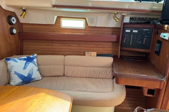 Slide: The Image of Interior of 1993 Hunter Vision 36 sailboat with cozy seating and nautical decor. - 5