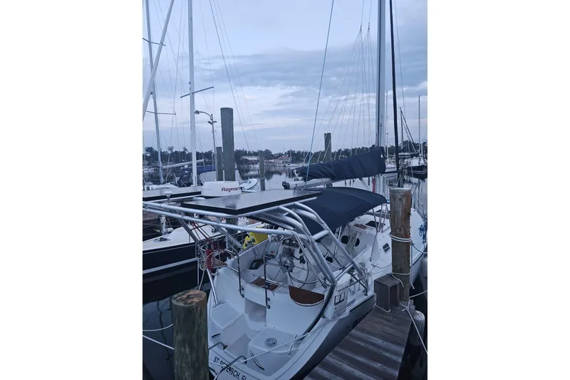Slide: The Image of 1993 Hunter Vision 36 sailboat docked at a marina, featuring a sleek design and modern equipment. - 6