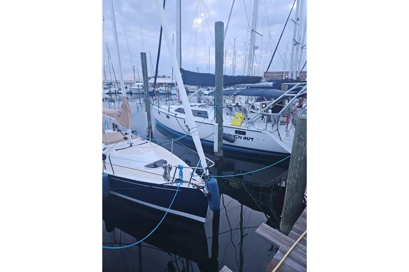 Slide: The Image of Sailboats docked at a marina, featuring a 1993 Hunter Vision 36. - 8