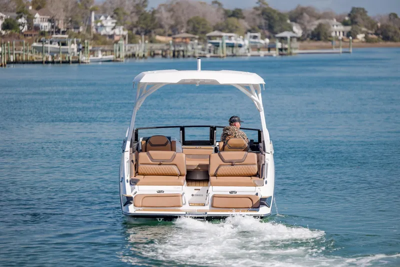 Slide: The Image of 2024 Yamaha Boats 275SD cruising on a serene waterway, showcasing luxury seating and sleek design. - 10
