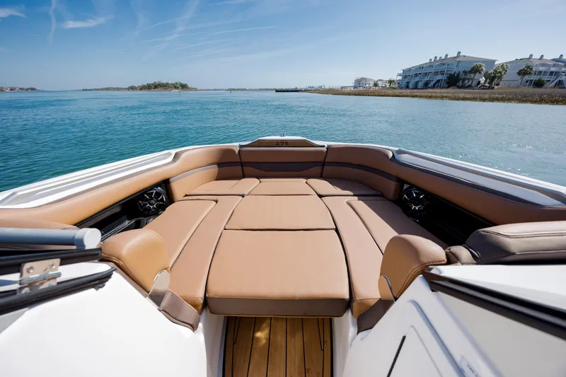 Slide: The Image of 2024 Yamaha Boats 275SD interior with luxurious seating on calm waters. - 11