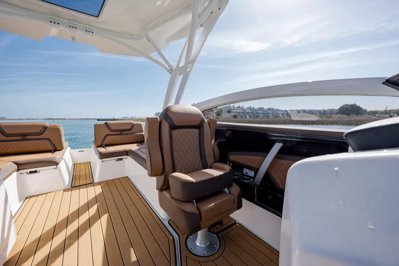 Slide: The Image of 2024 Yamaha Boats 275SD interior with luxurious seating and scenic water view. - 20